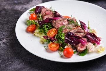 Grilled ribeye beef steak, salad, herbs and spices