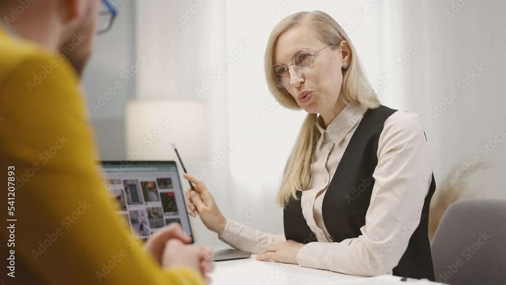 Poster professional designer discussing project with customer, showing visualisation variants