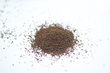 Dry black tea leaves isolated on white background