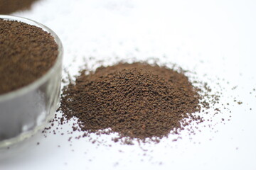 Dry black tea leaves decorated on white background
