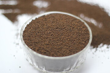 Dry black tea leaves decorated on white background