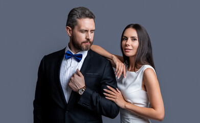 caucasian formal tuxedo couple isolated on grey background. couple in formal tuxedo.