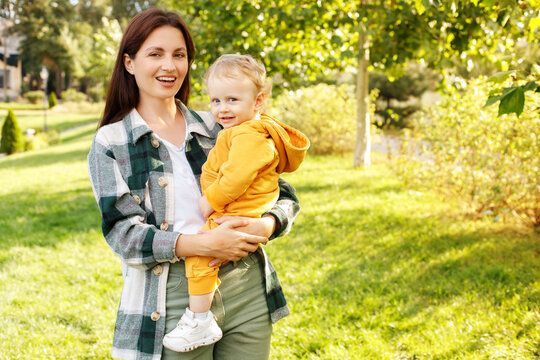 Portrait Mom And Son 1 Year Old In The Park For A Walk