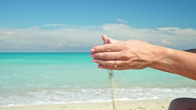 Sand Grains Run Through Female Hands. Woman Holding and Releasing Sand Through Fingers. Irreversible Flow of Time. Loss and Inconvertibility