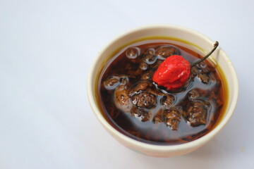 Homemade mango pickle isolated, Spicy red naga chili pickle