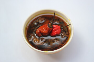 Homemade mango pickle isolated, Spicy red naga chili pickle