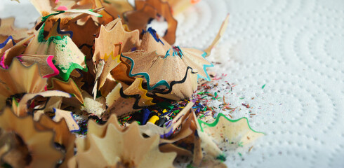 shavings from wooden colored pencils. background for the design.