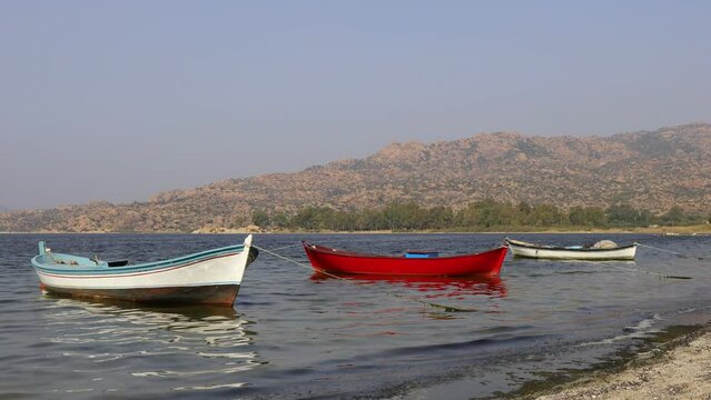 Fishing boats moored along the shore of Lake Bafa in Turkey.