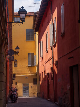 Red and yellow buildings on street of Bologna - Bologna, Italy