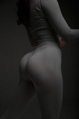 Naklejka premium Athletic sexy buttocks of a girl smeared with oil. Drops of oil on juicy buttocks