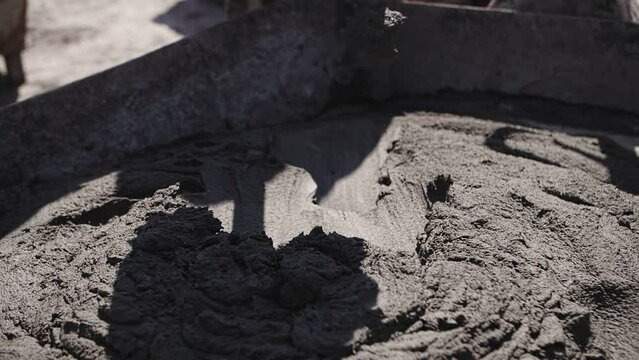 concrete is stirred with a shovel