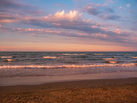 Purple sunset on the sandy beach - Rimini, Italy