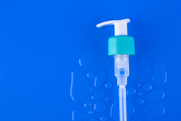 Drops of moisturized serum, essential with white dispenser on violet background. Flatlay close up. organic gentle facial skincare, сleansing micellar water product cleanser