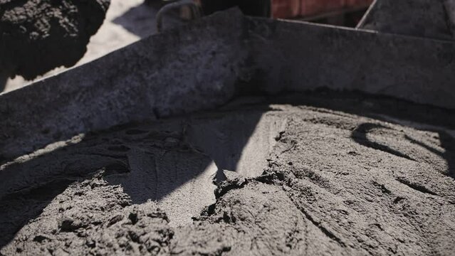 concrete is stirred with a shovel