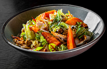 Chicken, carrot, lettice and tomato salad on bowl