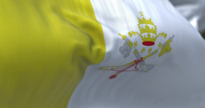Close-up view of the Vatican City national flag waving in the wind.