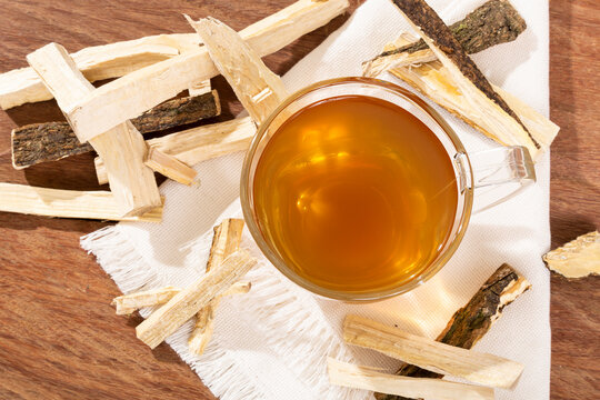 Quassia Amara - Beverage Stems Of Quassia Medicinal plant; On Wood Background
