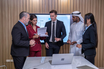 Group of business diversity people and middle east in office in the meeting room stand near big screen TV presentation contract agreement and signature close deal clap hands