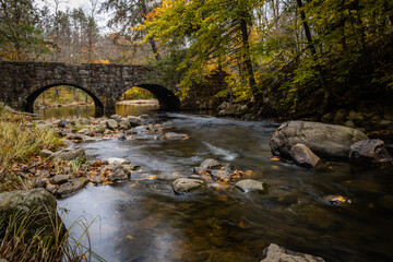 Stokes State Forest in Sussex County, NJ, is basked in brilliant autumn colors as the Flatbrook gently graces the rocks