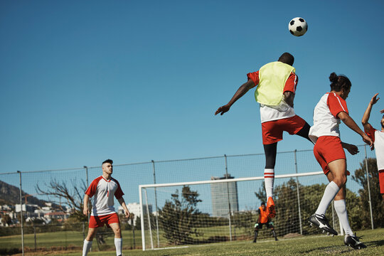 Soccer, sports and training with a team on a field or grass pitch for a workout or exercise together. Football, fitness and teamwork with a soccer player group playing a game or match outdoor