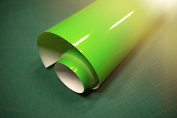 A roll of green vinyl film for design on a cut table. Film for plotter cutting.