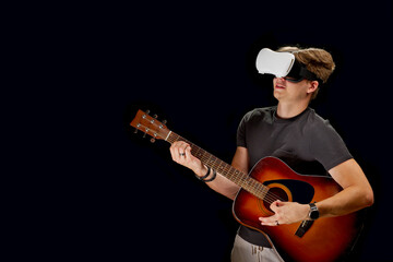 Man action playing guitar game in virtual reality helmet. VR glasses, on black isolated background. virtual glasses, goggles, helmet