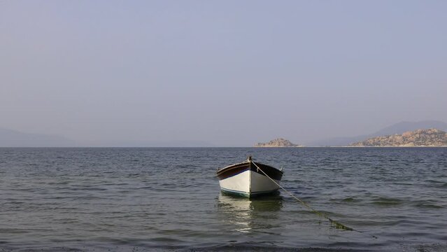 Fishing boats moored along the shore of Lake Bafa in Turkey.