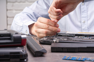 Notebook repair. Man disassembles a laptop. Removes the keyboard. Computer service and repair...