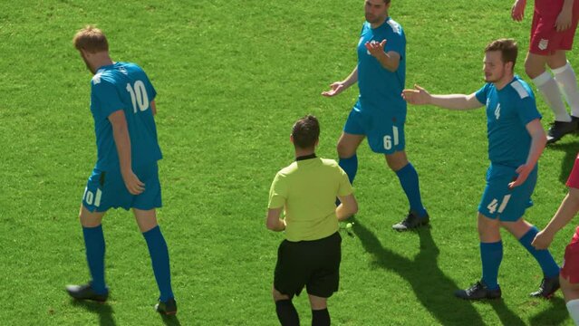 Soccer Football Championship Match: Referee Sees Foul, Gives Signal and Yellow Card, Players Circle him Upset. International Tournament. Sport Broadcast Channel Television Playback. Slow Motion