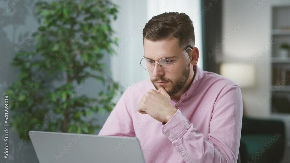 Poster young bearded man working with devices at home, handsome smart businessman using tablet and laptop f
