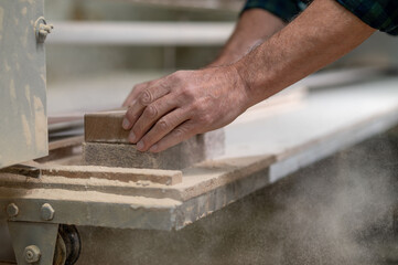 Craft person working with wood in a workshop