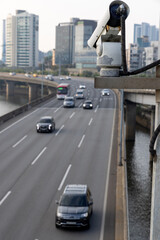 Security camera on the bridge watching after the car traffic, and speed control. Closeup of traffic security camera surveillance (CCTV) on the road in the big city.