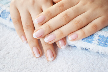 Hand and nail care with French style manicure with white polish
