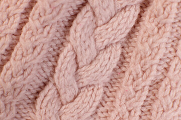 texture hand-knitted or machine knitting pattern braid. fabric background close-up