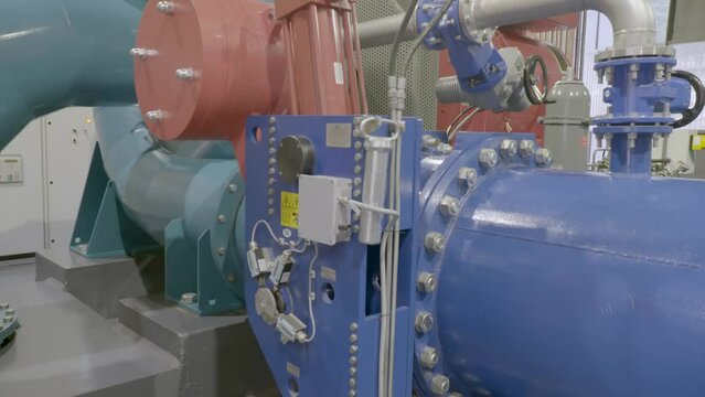 Hydro electric power generator in a mini hydropower plant. The interior of the hydropower plant