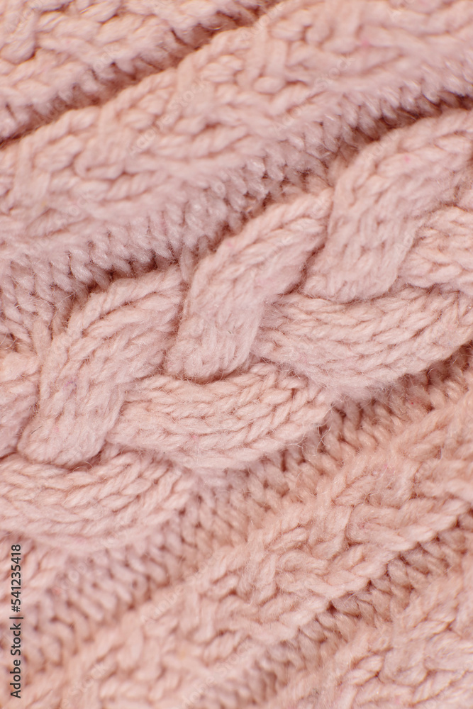 Poster texture hand-knitted or machine knitting pattern braid. fabric background close-up. vertical orienta
