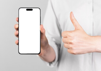 Obraz na płótnie Canvas iphone 14 pro screen mockup. Mobile phone mock up and thumbup gesture. High quality photo