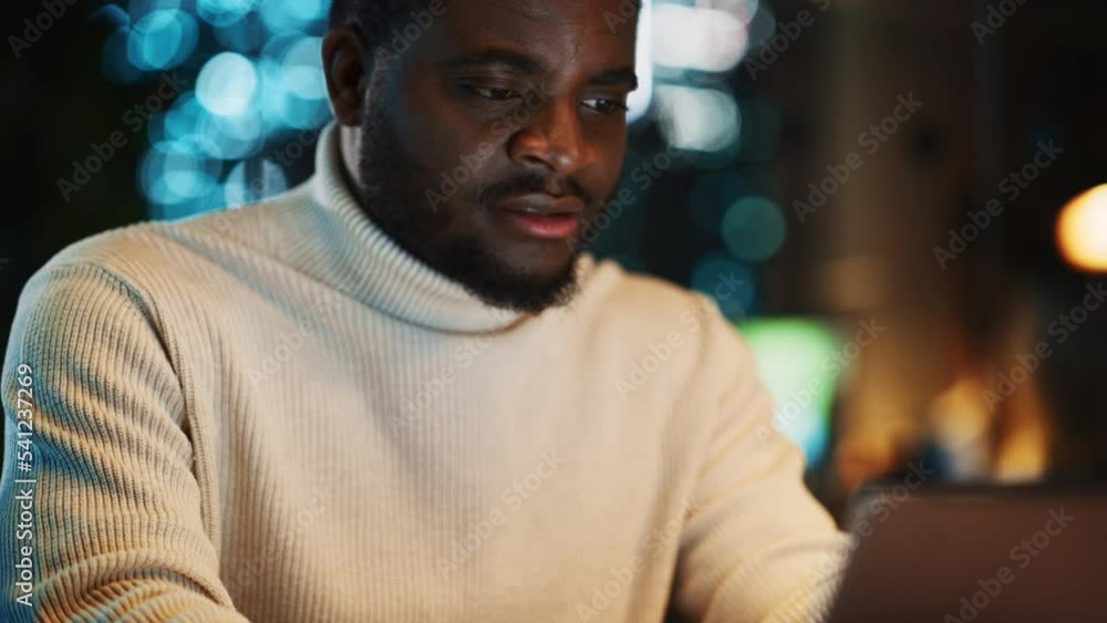 Aufkleber Close Up Portrait of a Creative Project Manager Working on a Laptop Computer in an Office at Night. African American Marketing Specialist Planning a Project, Browsing Internet and Writing Emails.