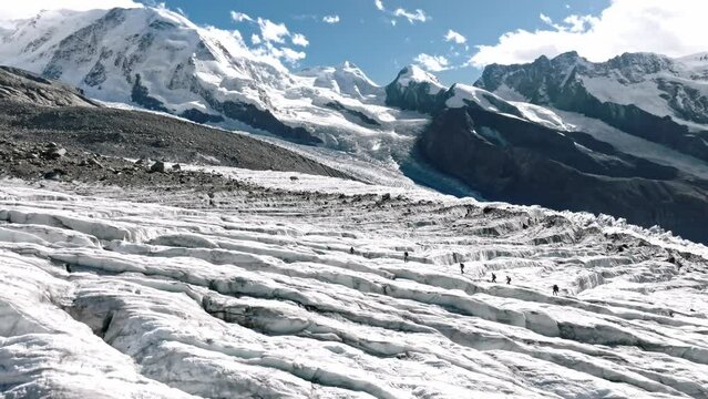 walking people over the Monte Rosa glacier in Switzerland. drone move down