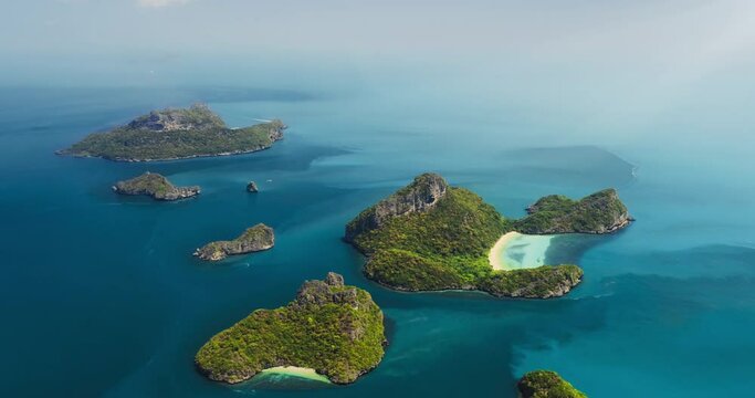 Green tropical island in blue ocean water aerial view. Exotic nature top drone landscape. Paradise beach vacation travel. Sea summer sunny seascape background. Ang Thong National Park. Thailand, Asia.
