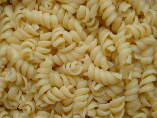 Cooking Italian pasta, at home. Boiled Penne macaroni. Vegetarian food. Background of cooked pasta