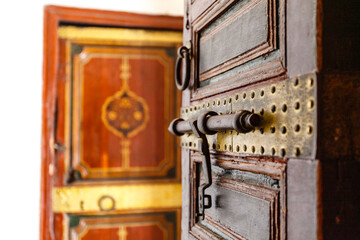 Rich decorated wooden door with lock inside of the Bahia Palace, Marrkesh, Morocco, North Afrcia