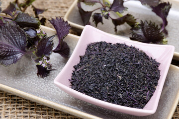 Yukari rice seasoning made of shiso (perilla) leaves in a bowl. Purple herb leaf ingredient in Asian cuisine.