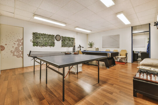 Lounge area in office with pool and tennis table