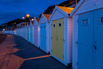 Fototapeta premium beach huts along the promenade at Lyme Regis Dorest England at dawn before sunrise