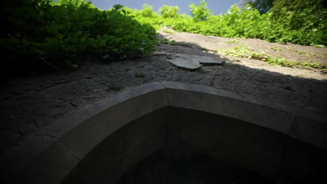 Slow motion low angle shot of old Irish church ruins in Westmeath, Ireland covered by grass