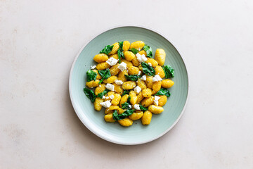 Pumpkin gnocchi with spinach and white cheese. Healthy eating. Vegetarian food.
