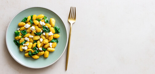 Pumpkin gnocchi with spinach and white cheese. Healthy eating. Vegetarian food.