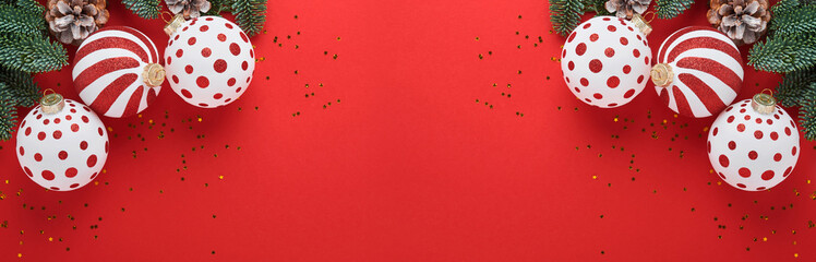 Christmas or New Year concept with white and red baubles ball, gift box and champagne with decorated ribbon and fir tree branches on red background. Happy New Year 2022. Mock up.