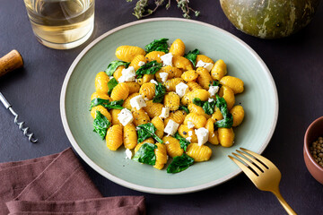 Pumpkin gnocchi with spinach and white cheese. Healthy eating. Vegetarian food.